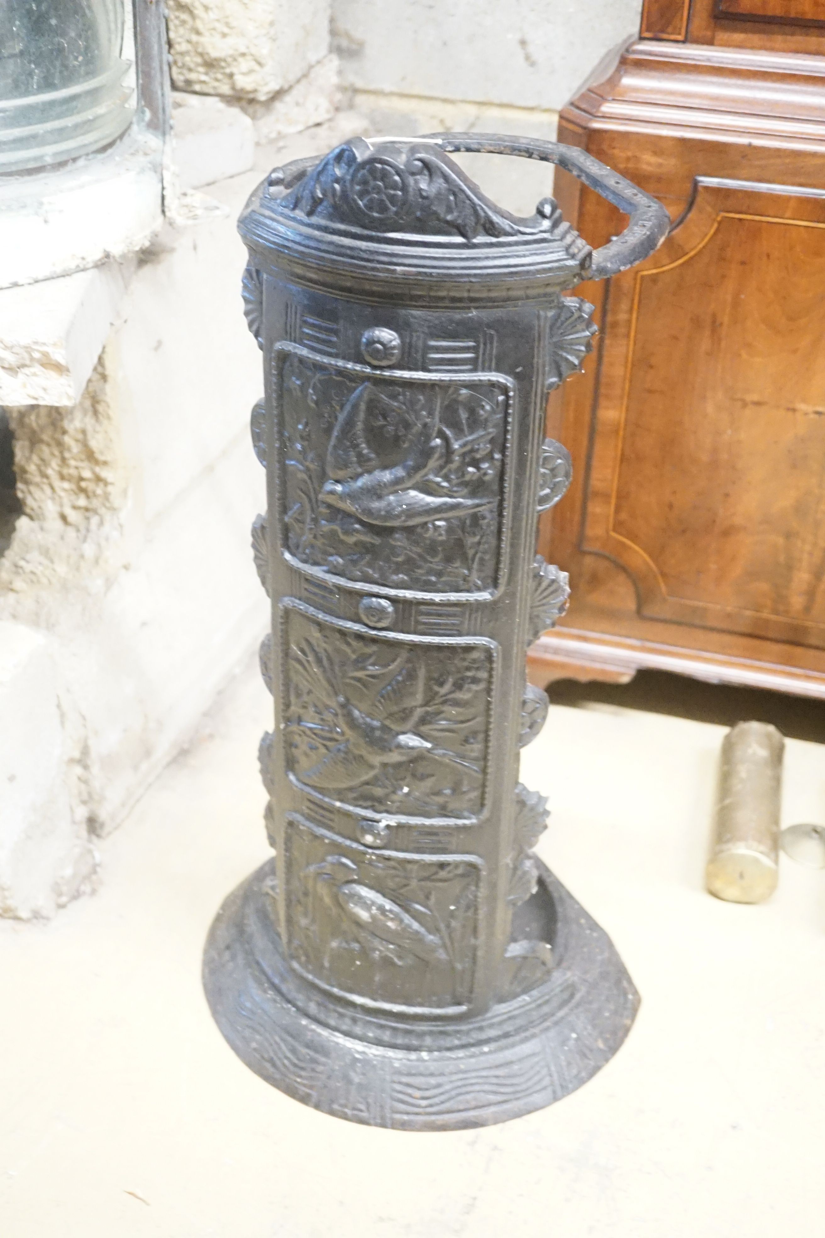 A cast iron panelled umbrella stand, height 66cm